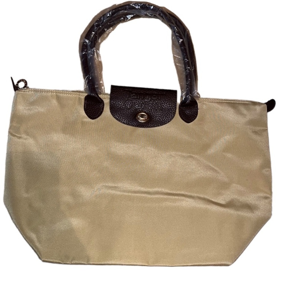 Nwot Tanger outlet tote bag with name on front and brown leather styled handles